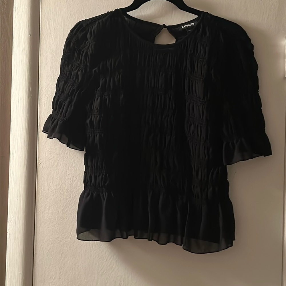 Black size medium Express top. Polyester with ruffle detail. New without tags